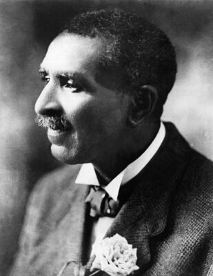 George Washington Carver with a rose in jacket lapel.